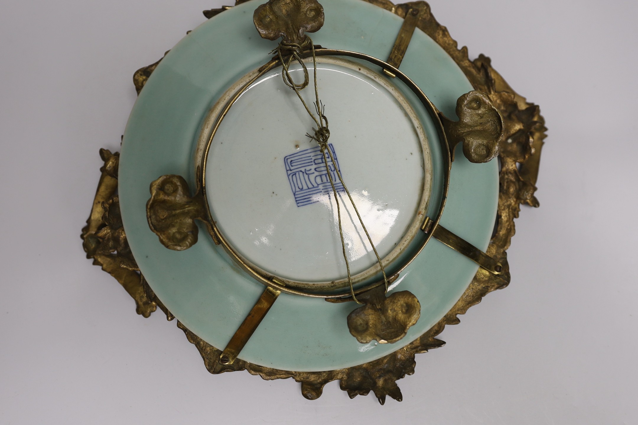 An ormolu-mounted Chinese celadon ground famille rose serving dish. 25cm wide